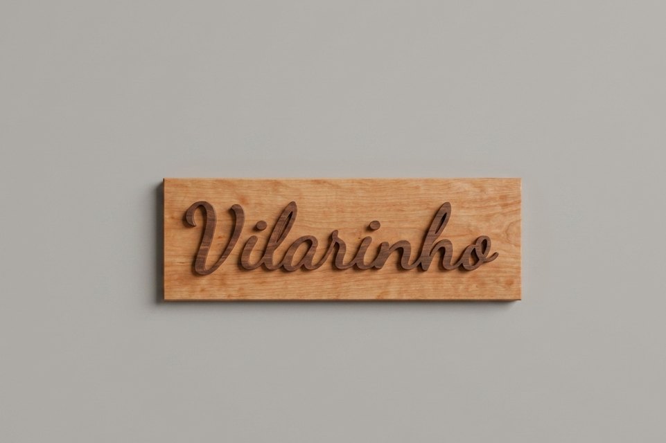 Cherry sign with the name Vilarinho cut in raised walnut script lettering